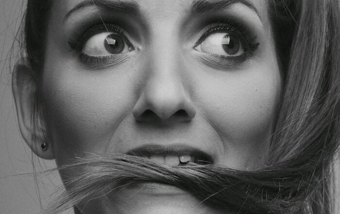 Artistic black and white portrait of a woman displaying a worried expression.